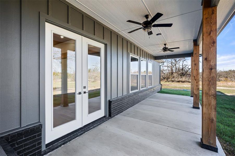 View of patio with ceiling fan and french doors