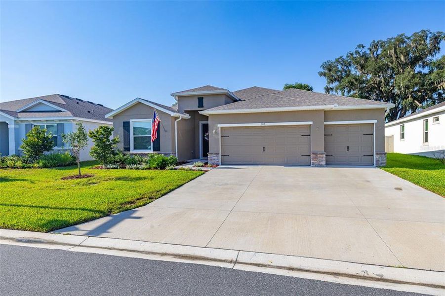 Front exterior of a new home in Farm at Varrea, Plant City, FL, highlighting curb appeal (Image 2). Front exterior of a new home in Farm at Varrea, Plant City, FL, highlighting curb appeal (Image 2).