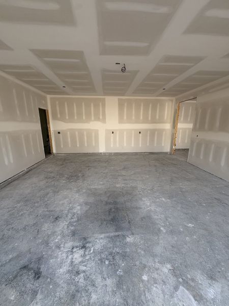 2 Car Garage with open door way to 3rd garage. 2 Car Garage with open door way to 3rd garage.