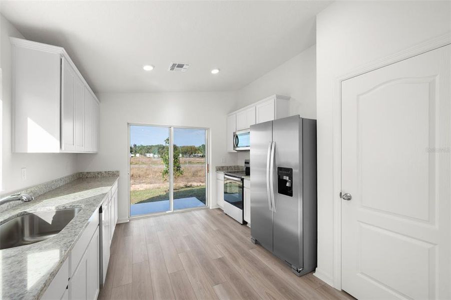 Furnished interior view inside a new home in Tula Parc, Astatula (Image 5).