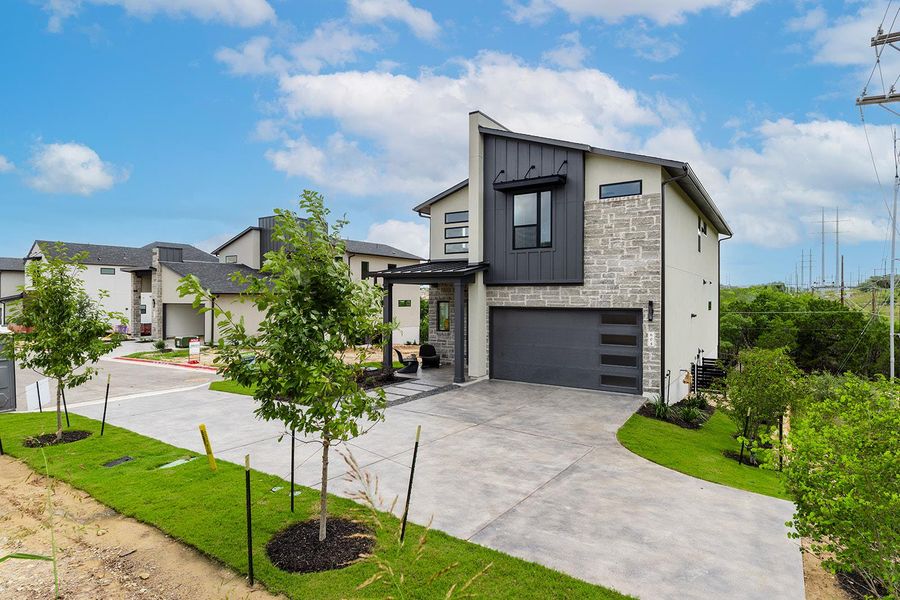 Corner lot with additional driveway space, with green space on side and behind homesite