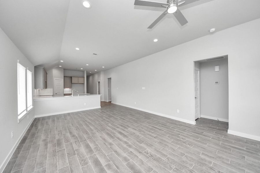 Bring your loved ones and guests together in the inviting living room! Boasting lofty high ceilings, recessed lighting, a stylish ceiling fan, custom paint, stunning flooring, and expansive windows that flood the space with ample natural light all day long. Bring your loved ones and guests together in the inviting living room! Boasting lofty high ceilings, recessed lighting, a stylish ceiling fan, custom paint, stunning flooring, and expansive windows that flood the space with ample natural light all day long.