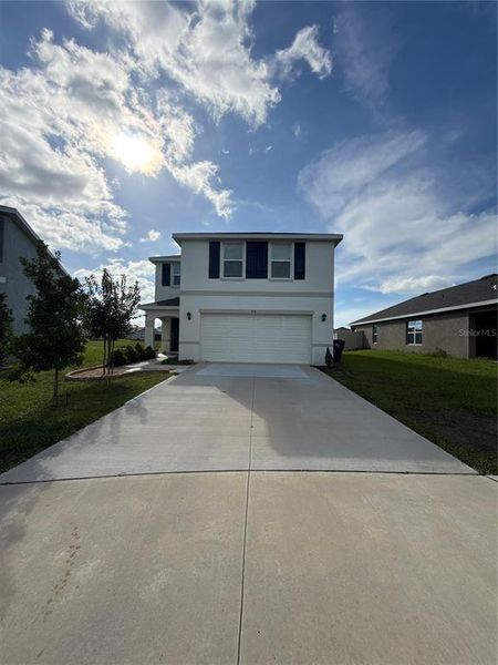 Front exterior of a new home in Evergreen, Bradenton, FL, highlighting curb appeal (Image 18). Front exterior of a new home in Evergreen, Bradenton, FL, highlighting curb appeal (Image 18).