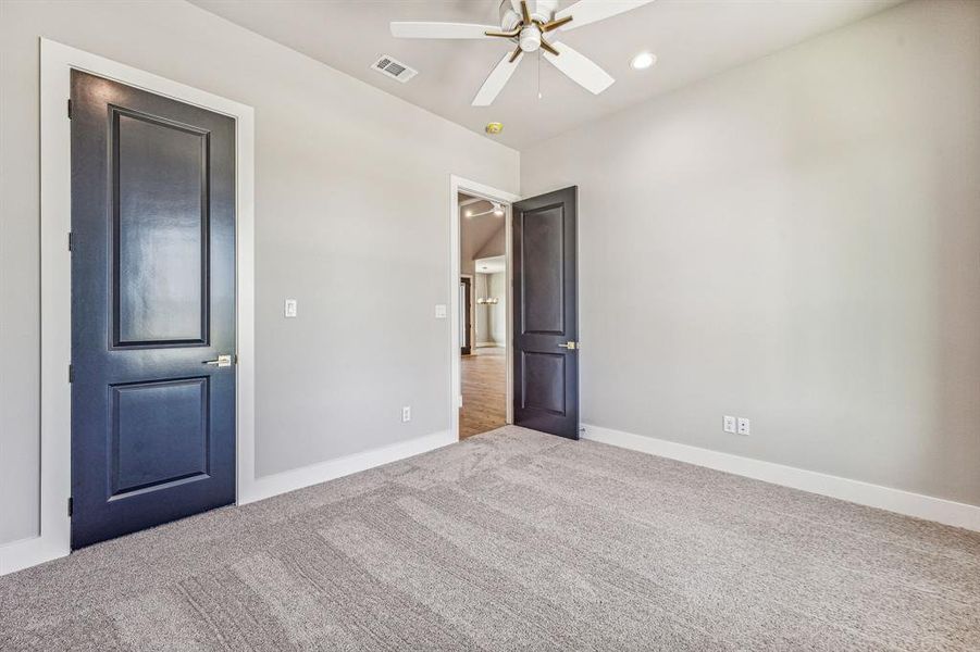 Unfurnished bedroom with carpet floors and ceiling fan