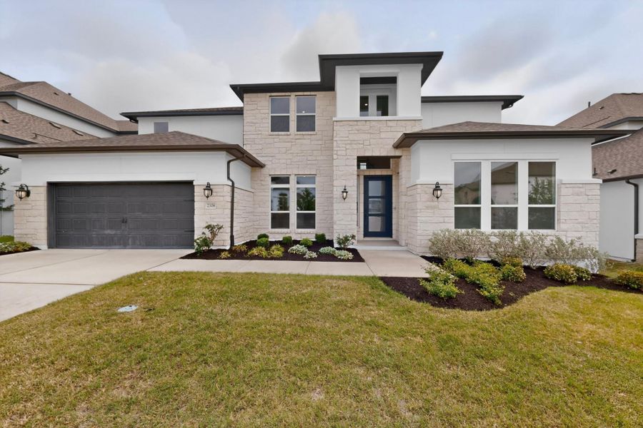 Contemporary facade featuring light-toned stone and white stucco accents