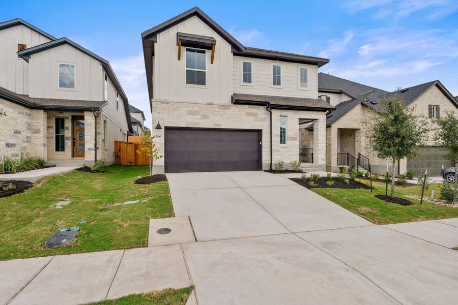 Front exterior of a new home in Heritage, Dripping Springs, TX, highlighting curb appeal (Image 25). Front exterior of a new home in Heritage, Dripping Springs, TX, highlighting curb appeal (Image 25).