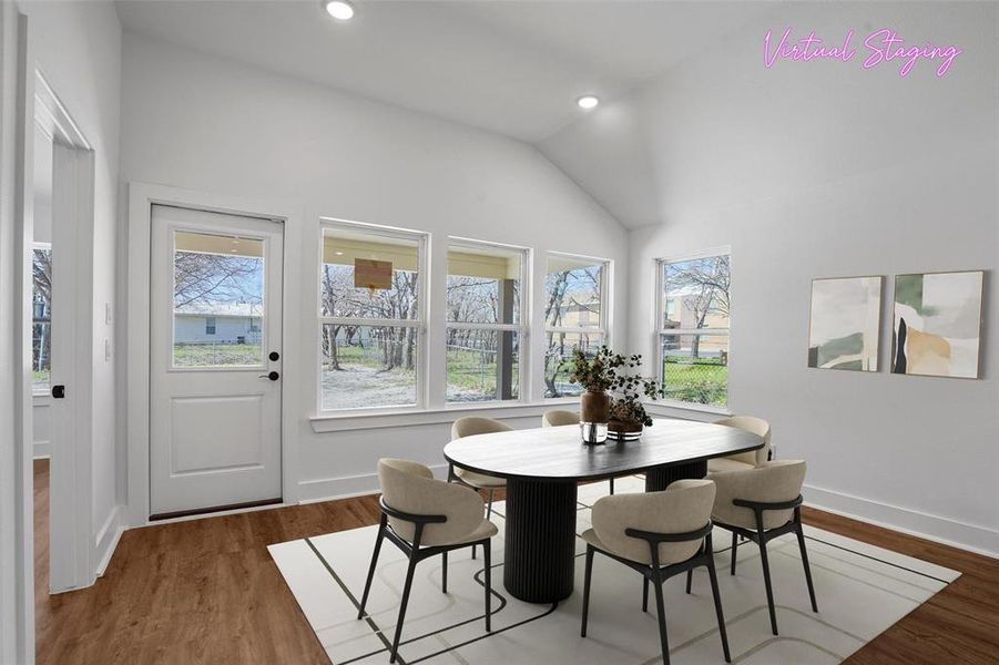 Dining room featuring recessed lighting, lofted ceiling, and wood finished floors