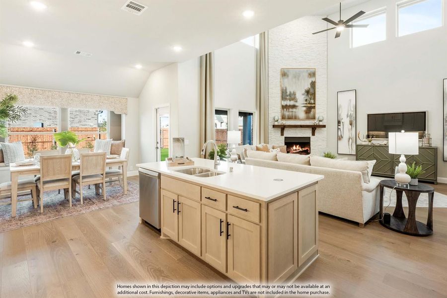 Open-concept living area with kitchen island, fireplace, dining space, and high ceilings with hardwood floors
