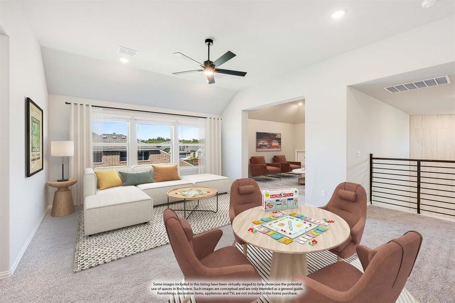 Upstairs bonus room with vaulted ceiling, ceiling fan, seating area, and game table near stair railing Upstairs bonus room with vaulted ceiling, ceiling fan, seating area, and game table near stair railing
