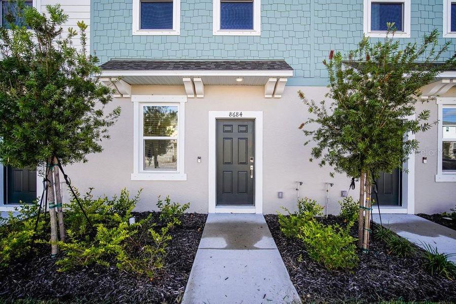 Exterior details and patio area of a home in The Townhomes at Skye Ranch, Sarasota (Image 4).