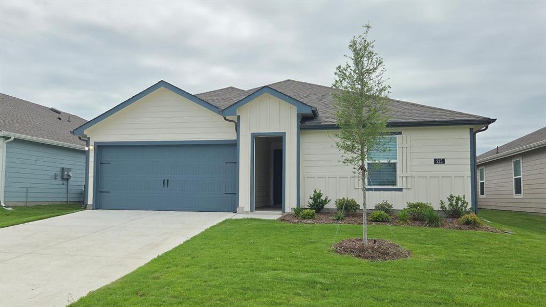 Single-story residence featuring a two-car garage with a blue door Single-story residence featuring a two-car garage with a blue door