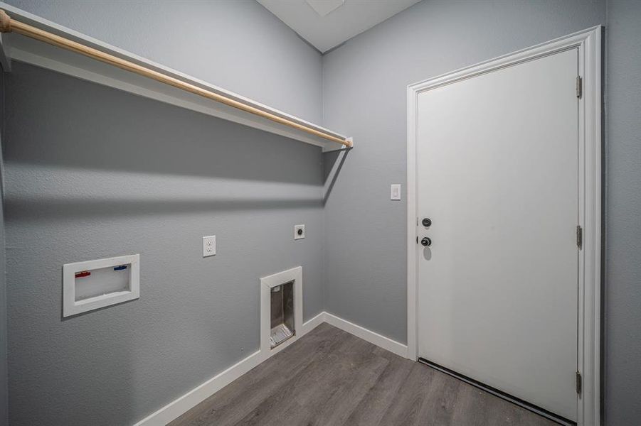 Washroom with dark wood-style floors, hookup for a washing machine, and electric dryer hookup Washroom with dark wood-style floors, hookup for a washing machine, and electric dryer hookup