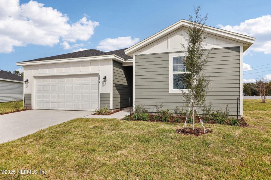 Front exterior of a new home in Cypress Meadows - Signature Series, Jacksonville, FL, highlighting curb appeal (Image 21).