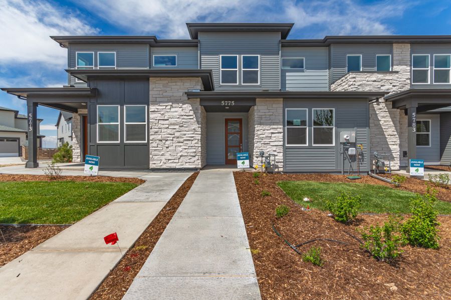 Front exterior of a new home in Painted Prairie, Aurora, CO, highlighting curb appeal (Image 1).