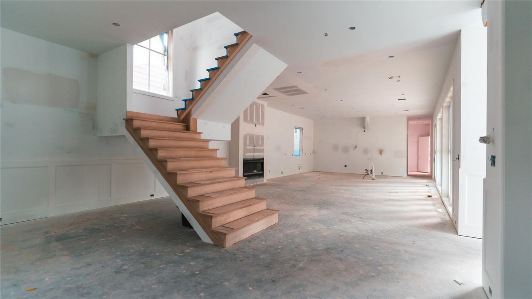Steel framed floating staircase provides a minimal but sturdy path to the second floor