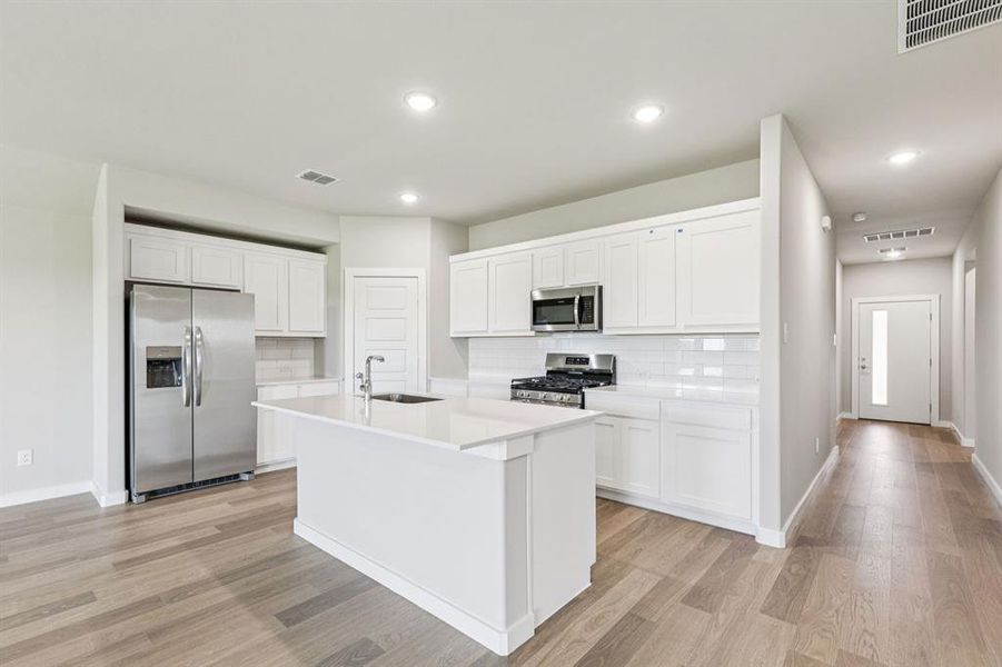 Kitchen in the Harper home plan by Trophy Signature Homes – REPRESENTATIVE PHOTO