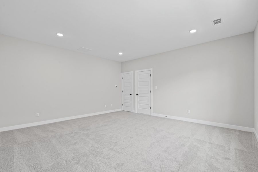 Empty room with light carpet and recessed lighting Empty room with light carpet and recessed lighting