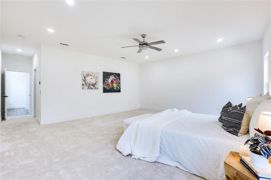 Bedroom featuring ceiling fan and light colored carpet