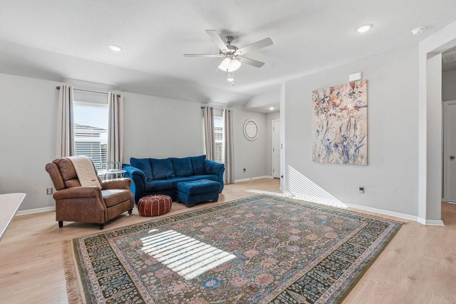 Living room with light wood-type flooring, ceiling fan, healthy amount of natural light, and recessed lighting Living room with light wood-type flooring, ceiling fan, healthy amount of natural light, and recessed lighting