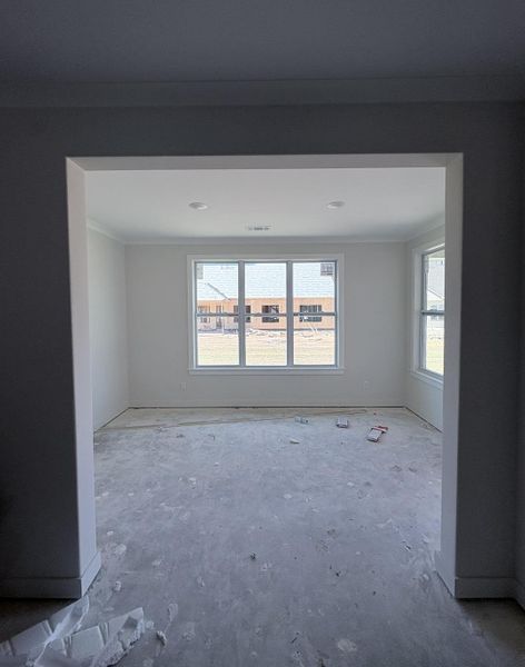 Recessed lighting, crown molding, white trim, multiple windows with white frames, and light-colored walls Recessed lighting, crown molding, white trim, multiple windows with white frames, and light-colored walls