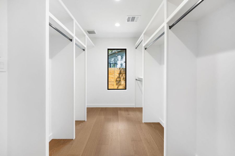 Spacious closet featuring light wood-style flooring