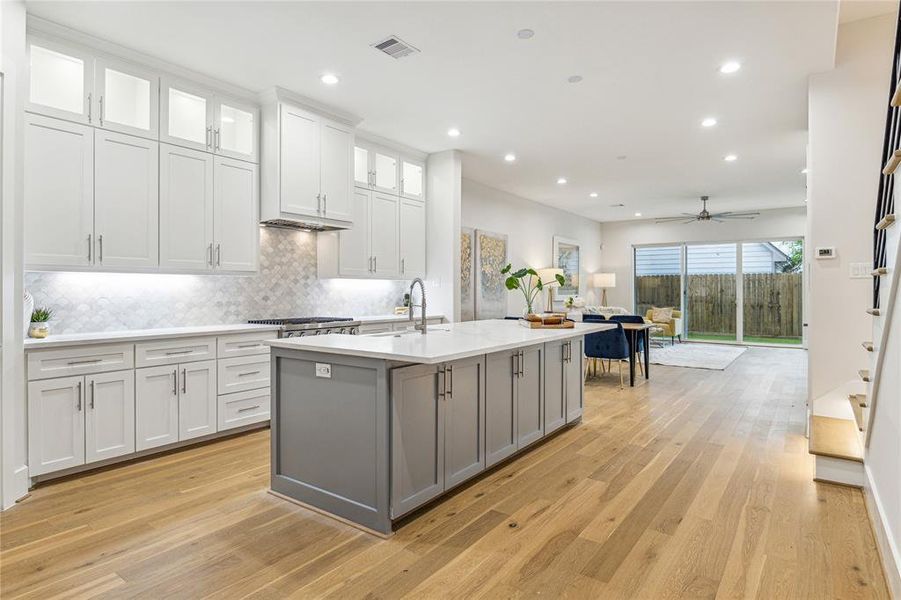 The kitchen features a stunning waterfall quartz island, elegantly designed to comfortably accommodate 4-5 guests. (Similar floor plan)