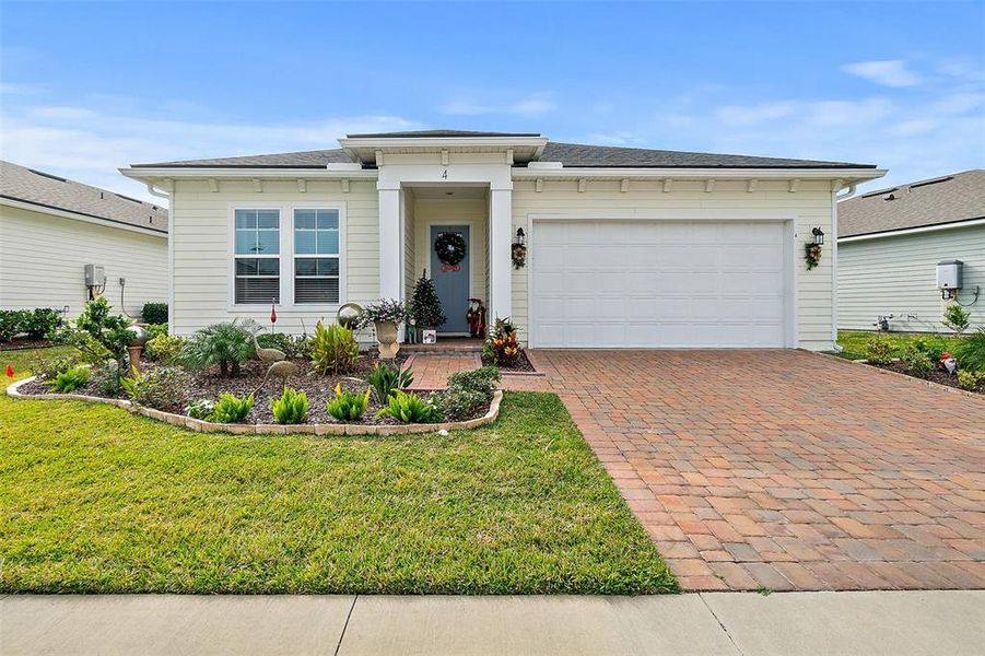 Front exterior of a new home in Reverie at Palm Coast, Palm Coast, FL, highlighting curb appeal (Image 2).