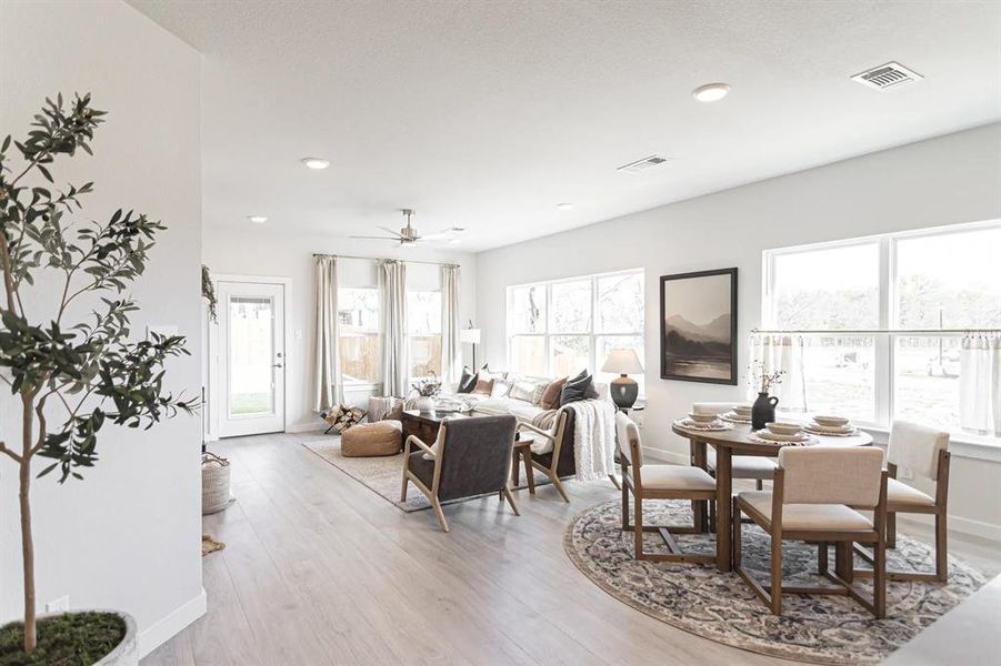 Dining room with a ceiling fan, light wood finished floors, and recessed lighting Dining room with a ceiling fan, light wood finished floors, and recessed lighting