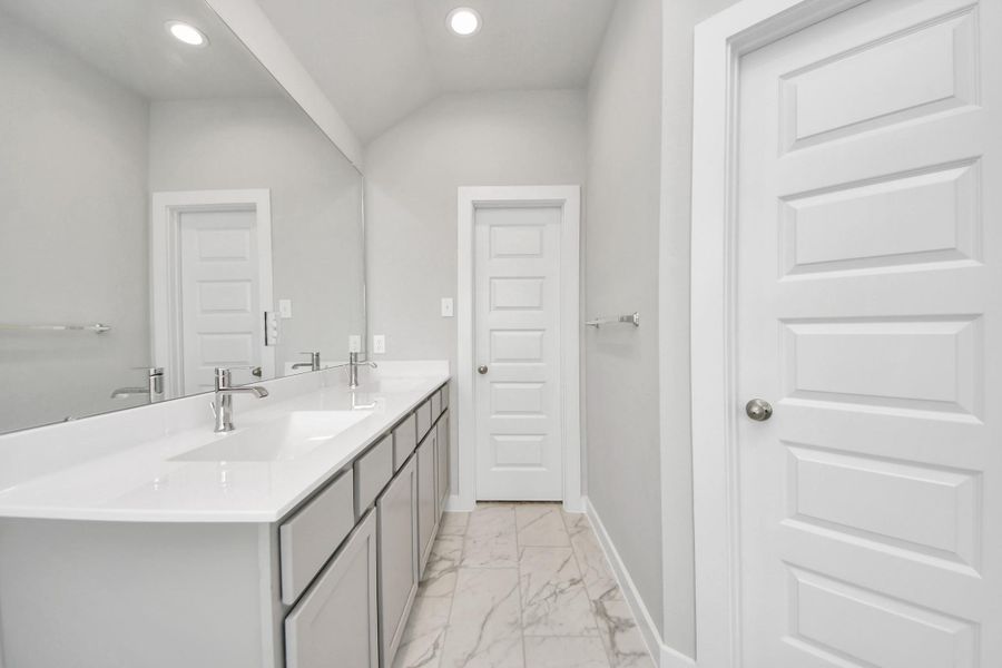 Elevate your daily routine at the elegant vanity, now equipped with double sinks, light countertops, modern hardware, and beautiful recessed lights. V Elevate your daily routine at the elegant vanity, now equipped with double sinks, light countertops, modern hardware, and beautiful recessed lights. V