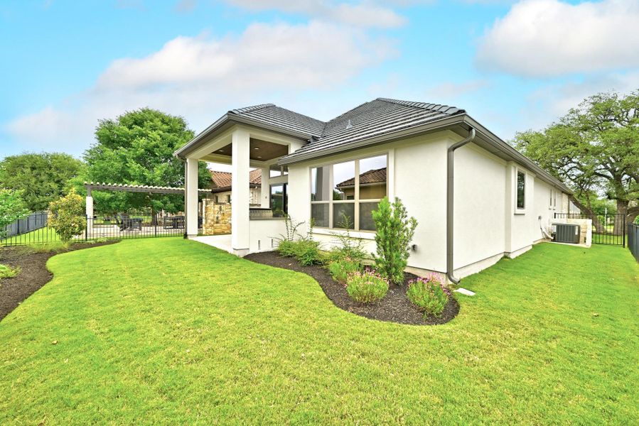 Contemporary stucco exterior with a dark tile roof