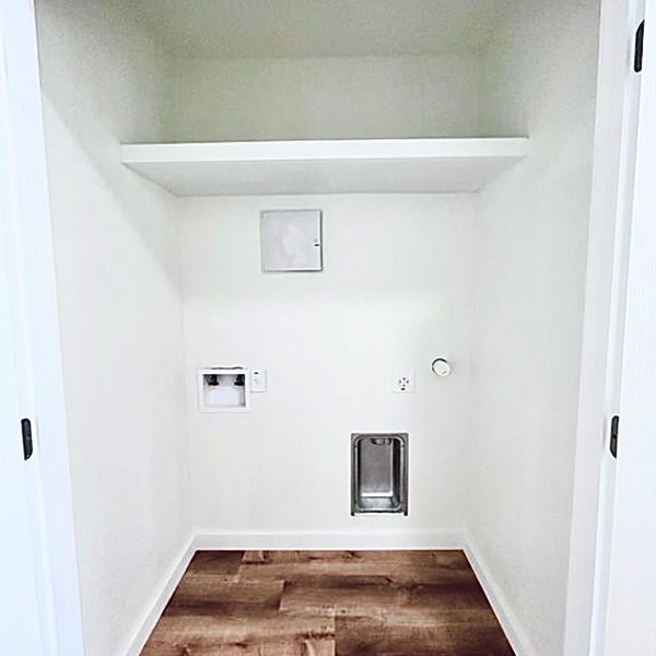A dedicated utility space with hookups and a convenient shelf for all your laundry needs.