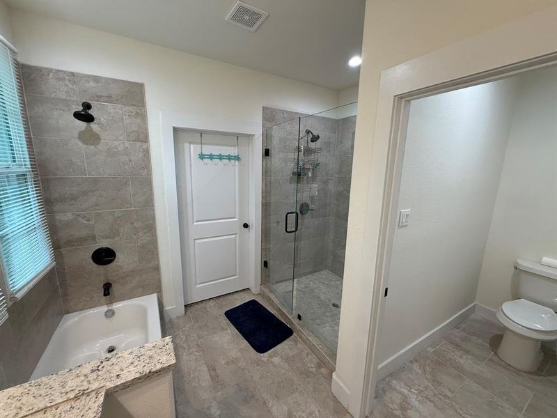 Bathroom featuring a shower stall and a garden tub