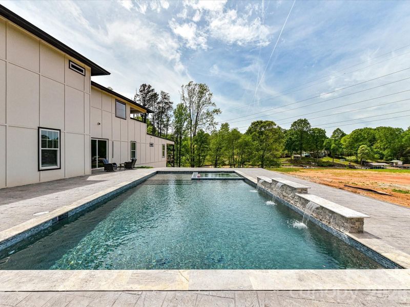 Spacious outdoor patio with an in-ground pool and spa, offering a great opportunity to customize your dream backyard retreat.