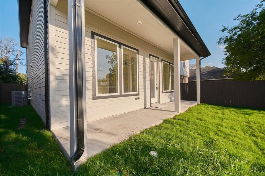 View of home's exterior with a patio, central air condition unit, and a yard