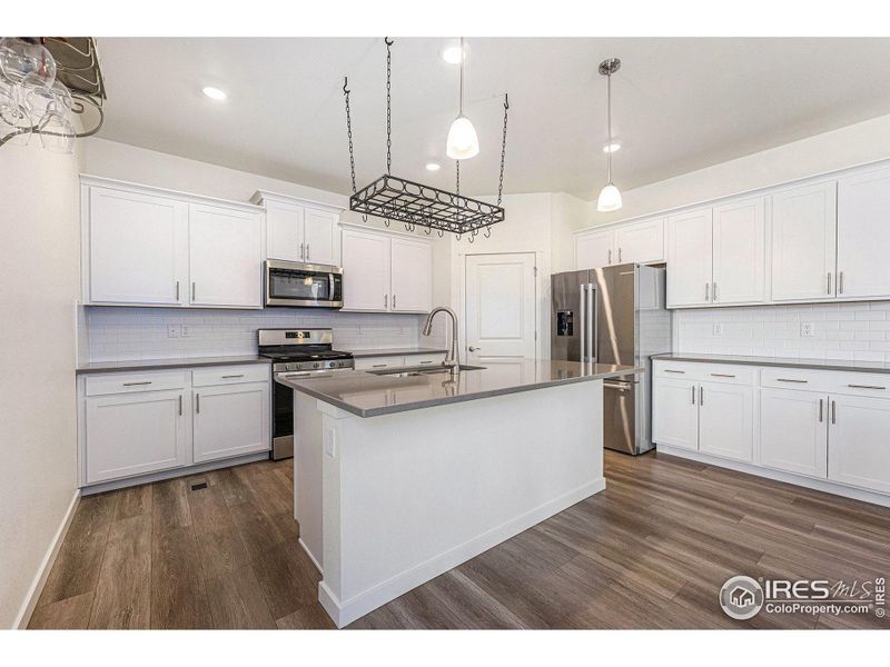 Abundant cabinetry, quartz countertops, stainless appliances