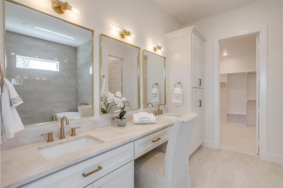 Bathroom featuring a tile shower and vanity