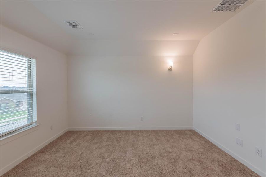 Empty room featuring carpet flooring and baseboards