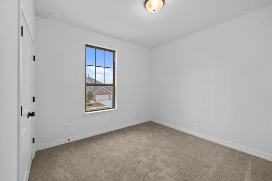 A secondary bedroom designed with soft neutrals and a relaxed, laidback feel.