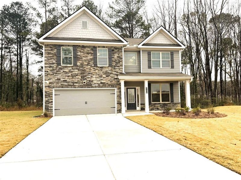 Front exterior of a new home in Paces Estates, Lithia Springs, GA, highlighting curb appeal (Image 1).