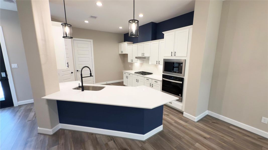 The ROCburne’s kitchen combines style and efficiency with spacious countertops, designer cabinetry, and an open-concept layout that keeps you connected to the heart of the home. Image depicts home as-is with some virtually elements. The ROCburne’s kitchen combines style and efficiency with spacious countertops, designer cabinetry, and an open-concept layout that keeps you connected to the heart of the home. Image depicts home as-is with some virtually elements.