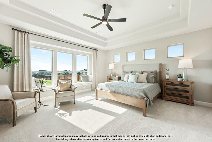 Spacious master bedroom with tray ceiling, ceiling fan, large windows, and neutral carpet Spacious master bedroom with tray ceiling, ceiling fan, large windows, and neutral carpet