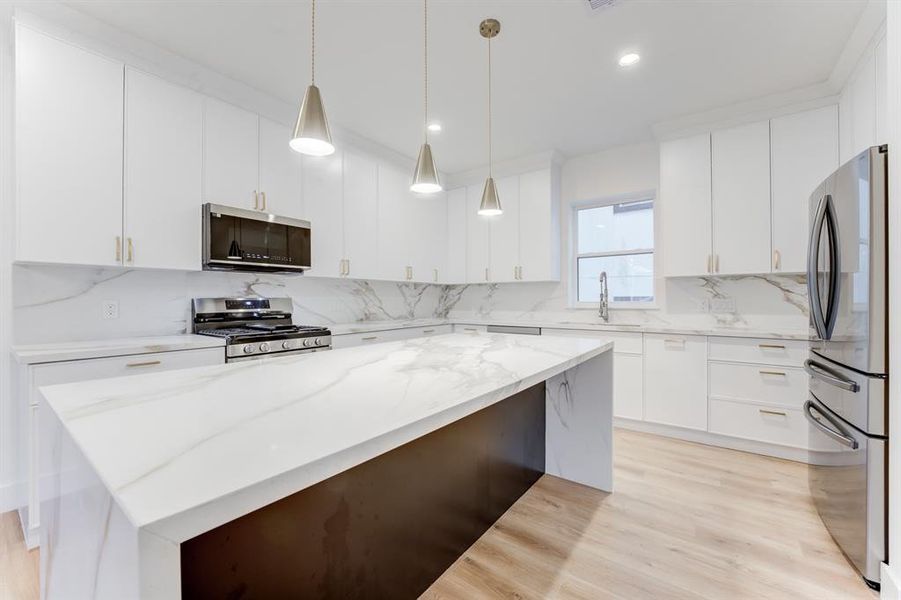 The stunning island kitchen is made for entertaining with space for barstools.