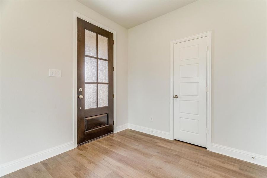 Entrance foyer featuring light hardwood / wood-style floors