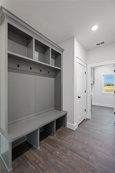 Mudroom with extra closet storage, leading into the laundry room