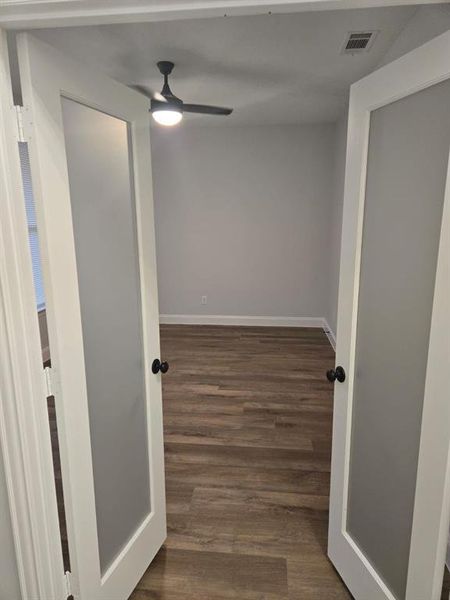 Corridor featuring dark wood-type flooring