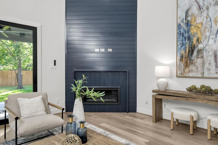 Cozy corner of the living area with accent wall and fireplace. Cozy corner of the living area with accent wall and fireplace.