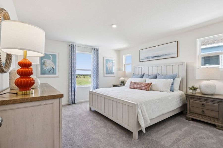 A bedroom with a bed and a lamp.