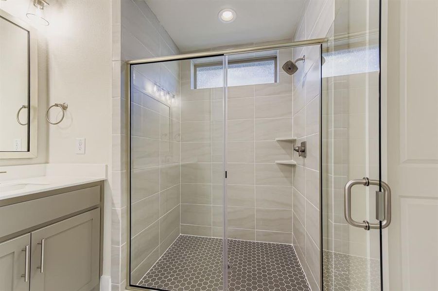 Full bathroom featuring vanity and a shower stall