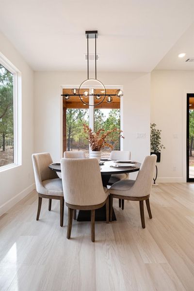 Dining area featuring healthy amount of natural light and a chandelier
