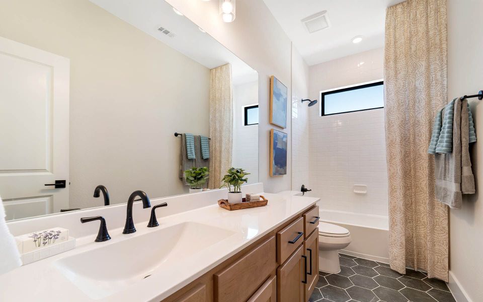 Representative furnished interior of a home built from the Rainier by CastleRock Communities in The Summit at Center Stage, Keller (Image 23).